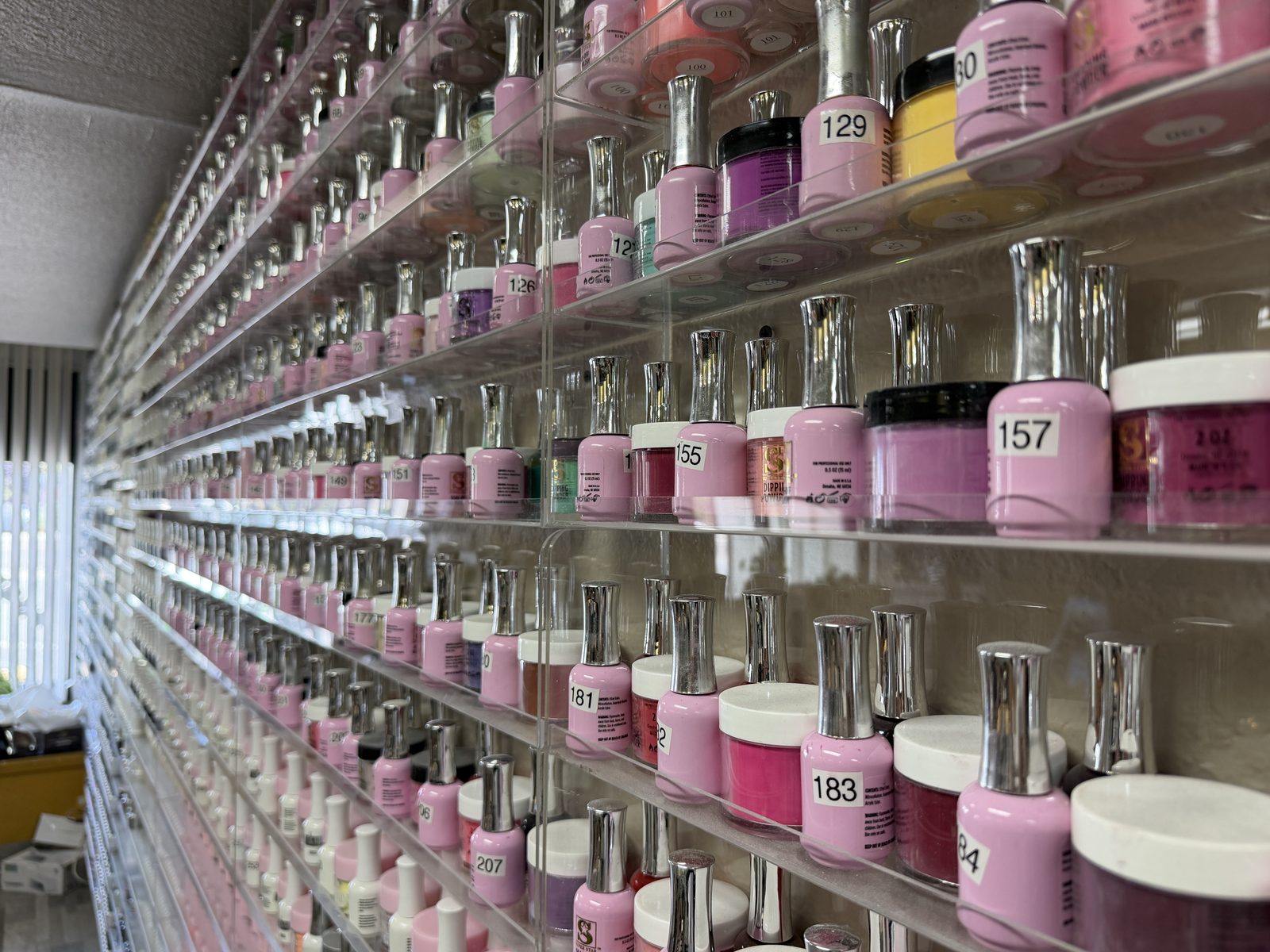 Wall of gel polish and dip powder colors at MC Nails & Spa